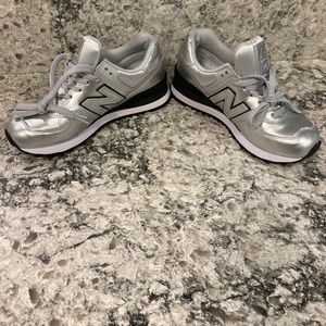 Size 36 Women’s Silver New Balance sneakers.